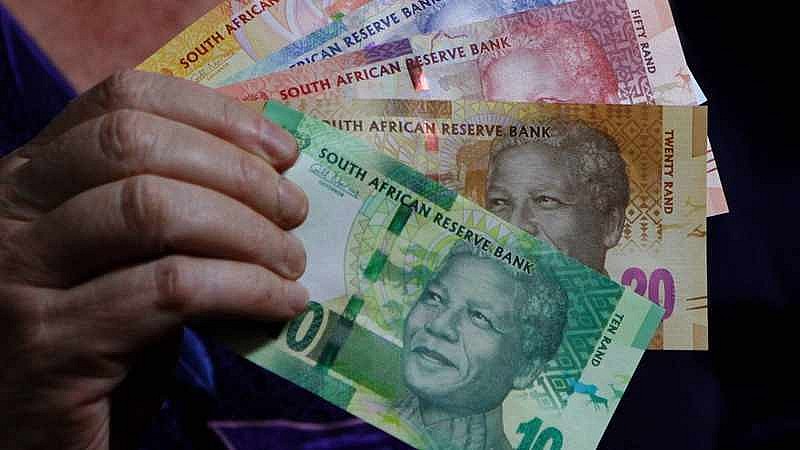 In this file picture, former Reserve Bank Governor Gill Marcus holds bank notes bearing the image of former President Nelson Mandela. Picture: AP