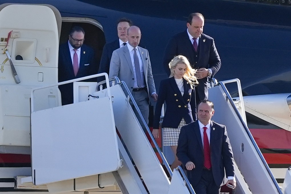 Natalie Harp (center stairwell) joined l. to r.) President-elect Donald Trump and his top advisers Jason Miller, Elon Musk, Stephen Miller, Boris Epshteyn and Dan Scavino on Nov. 13, 2024 for White House meeting with President Joe Biden