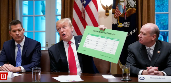 Trump with Duffy (left) and Robert Aderholt, holds a tariff table as he speaks in the Cabinet Room of the White House.