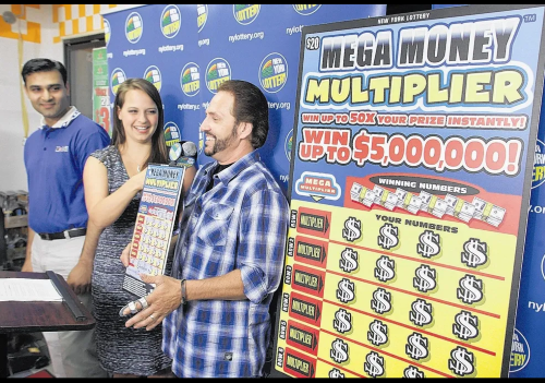 Gretchen Dizer, center, of the New York Lottery draw team introduces Andrew Porter of Loch Sheldrake as Sullivan County's newest and richest lottery millionaire during a ceremony at Loch Sheldrake Food Mart on Wednesday, June 27, 2012. Porter purchased a winning $5 million Mega Money Multiplier scratch-off ticket at the store on Route 52. Store owner Shahid Iqbal is at left.