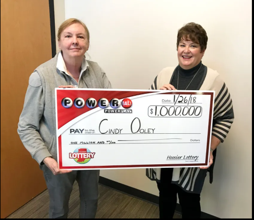 Cindy Ooley of Fishers holds the ceremonial check for $1 million Powerball win with Hoosier Lottery Executive Director Sarah Taylor.