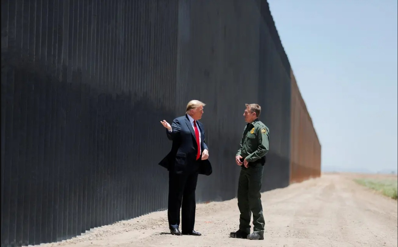 Rodney S. Scott, when was the Border Patrol chief, with President Donald J. Trump in front of the border wall in San Luis, Ariz., in 2020.