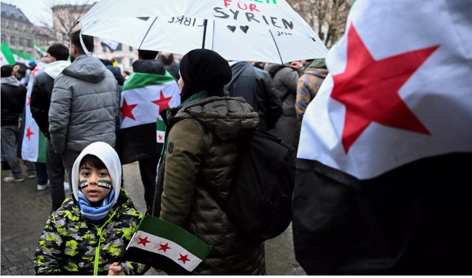 Syrians gather at Oranienplatz square in Berlin, Germany, waving opposition flags