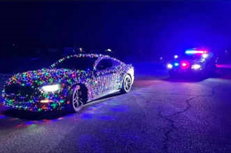 The Wyoming Highway Patrol shared an Instagram image featuring a Ford Mustang decorated with colourful Christmas bulbs