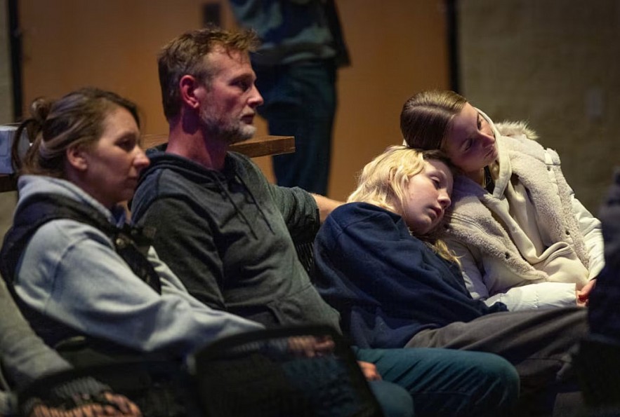 Families attend a prayer service to mourn the victims of Abundant Life Christian School in Madison, Wisconsin