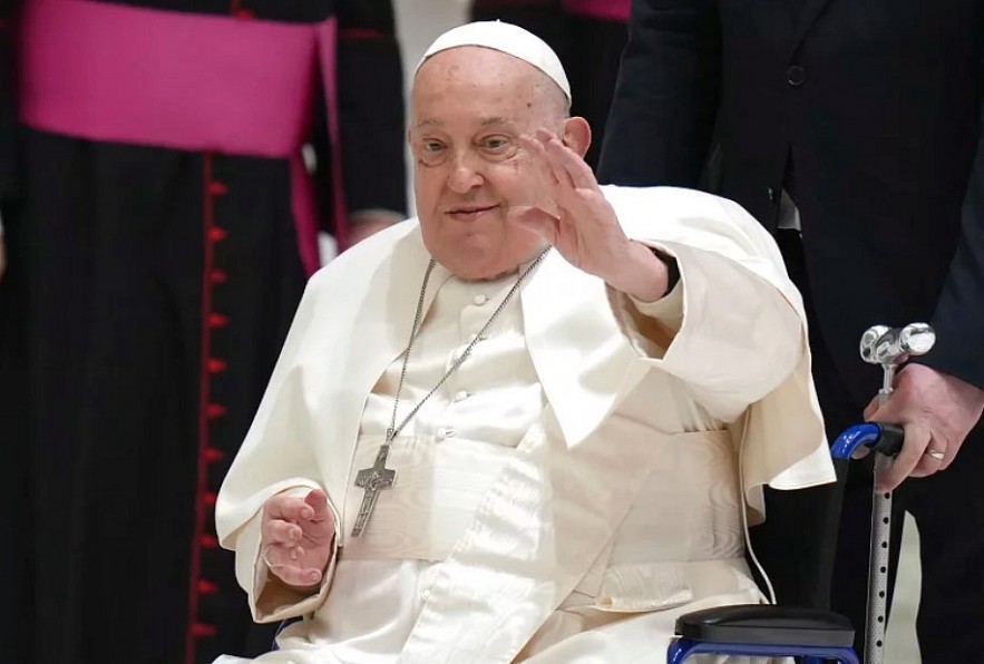 Pope Francis waves as he arrives for his weekly general audience in the Paul VI Hall, at the Vatican, Wednesday, Feb. 12, 2025