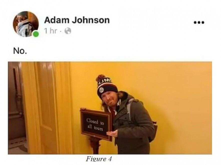 An image included in a federal sentencing memo shows a social media post in which Adam Johnson poses beside a sign during the Jan. 6, 2021, riot in the U.S. Capitol. [ U.S. District Court for the District of Columbia ]