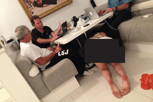 The New Epstein Photo That Shocked: Men at Work, a Bikini-Clad Woman Crawling Beneath the Table