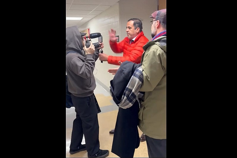 Ohio State assistant professor Luke Perez confronts two journalists in a hallway on Feb. 9, 2026