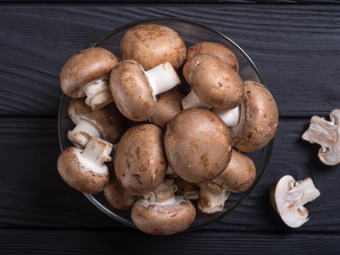 1150 mushrooms in a bowel on a dark table
