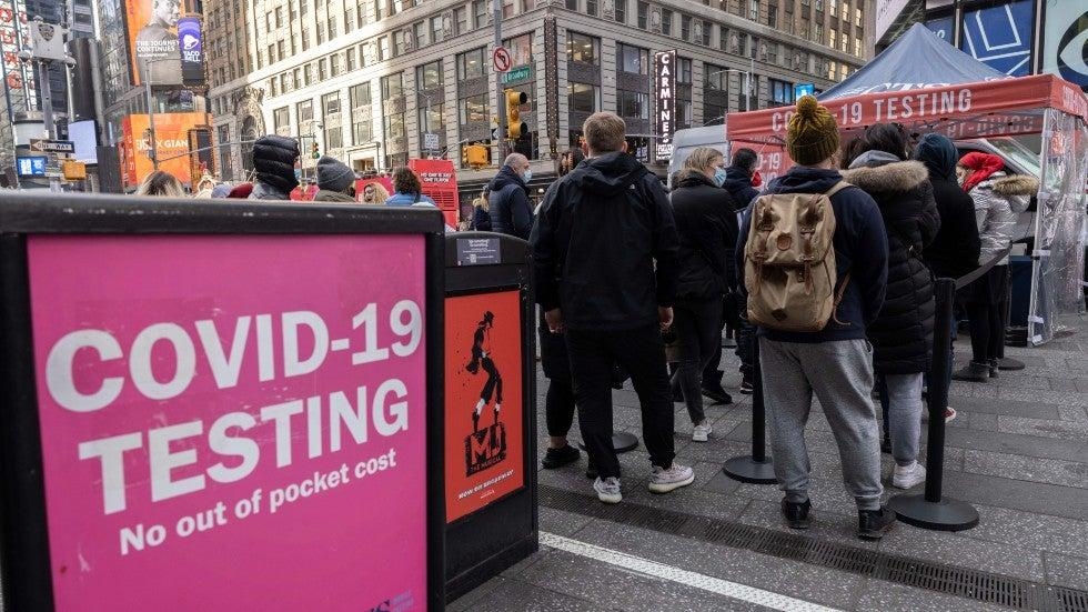 People wait in line to get tested for COVID-19 at a mobile testing site in Times Square. Photo: The Hill