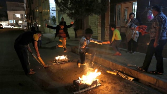 Iranian families light fire outside their houses in Tehran on March 13, 2018 during Chaharshanbe Soori.. Photo: Getty Images