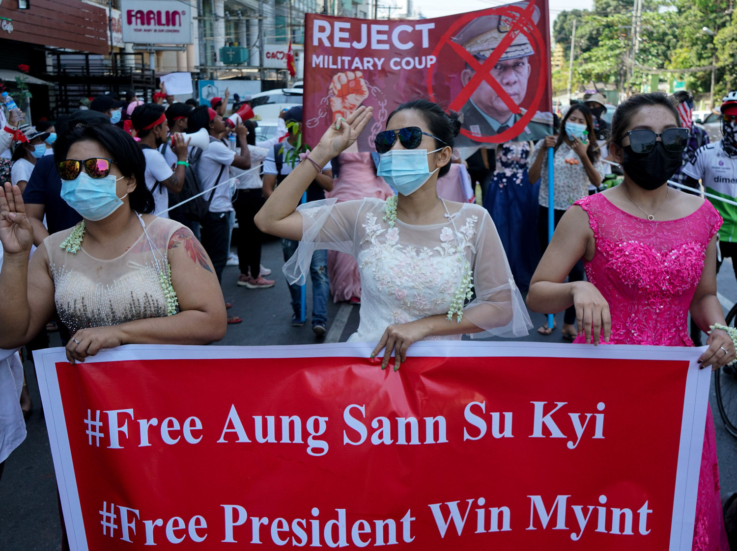 Women protest on Wednesday against the military coup that toppled the government led by Aung San Suu Kyi earlier this month. The Biden administration on Thursday announced sanctions against several of the coup leaders. Anadolu Agency via Getty Images.