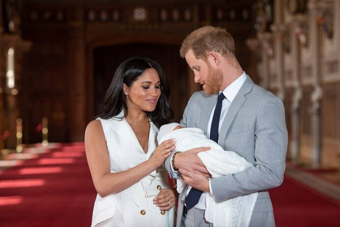 Britain’s Prince Harry and Meghan, Duchess of Sussex, pose during a photocall with their newborn son Archie, in St George’s Hall at Windsor Castle, Windsor, south England.