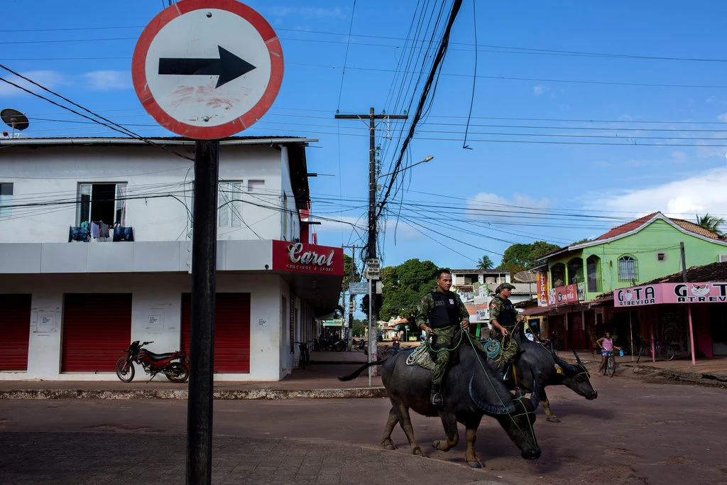 Military police officers patrolled on water buffaloes in Soure, a town of about 23,000 people on Marajó Island, as they have done since the 1990s.Credit...Marizilda Cruppe for The New York Times