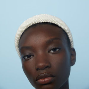 Woman wearing a white pearl Zara headband